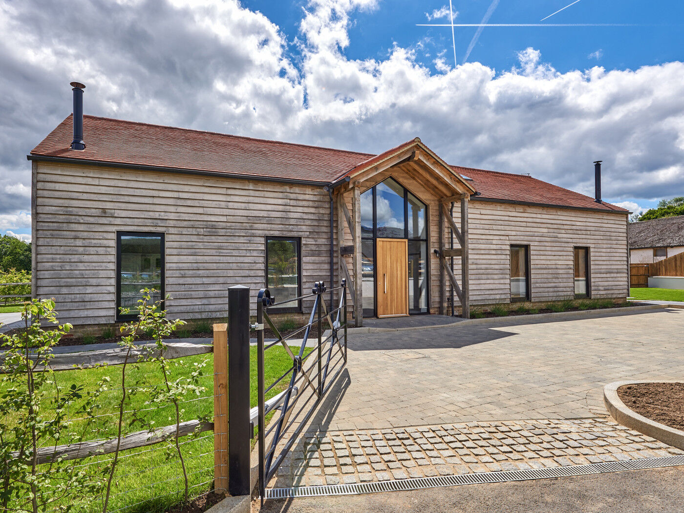 Mixing timbers in this project has a similar effect of highlighting the door but the glass framing also makes this entrance stand out