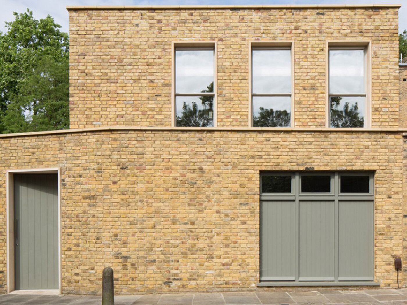 A sage green colour lifts the yellowish brick