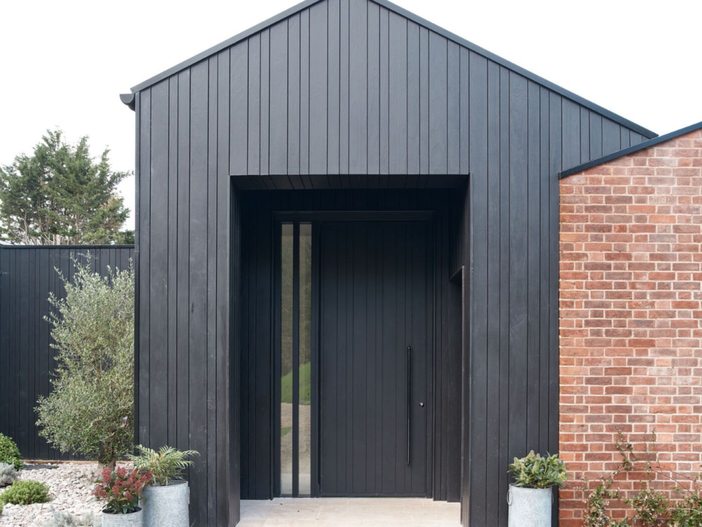 A great example of the impact you can create by matching door and cladding.