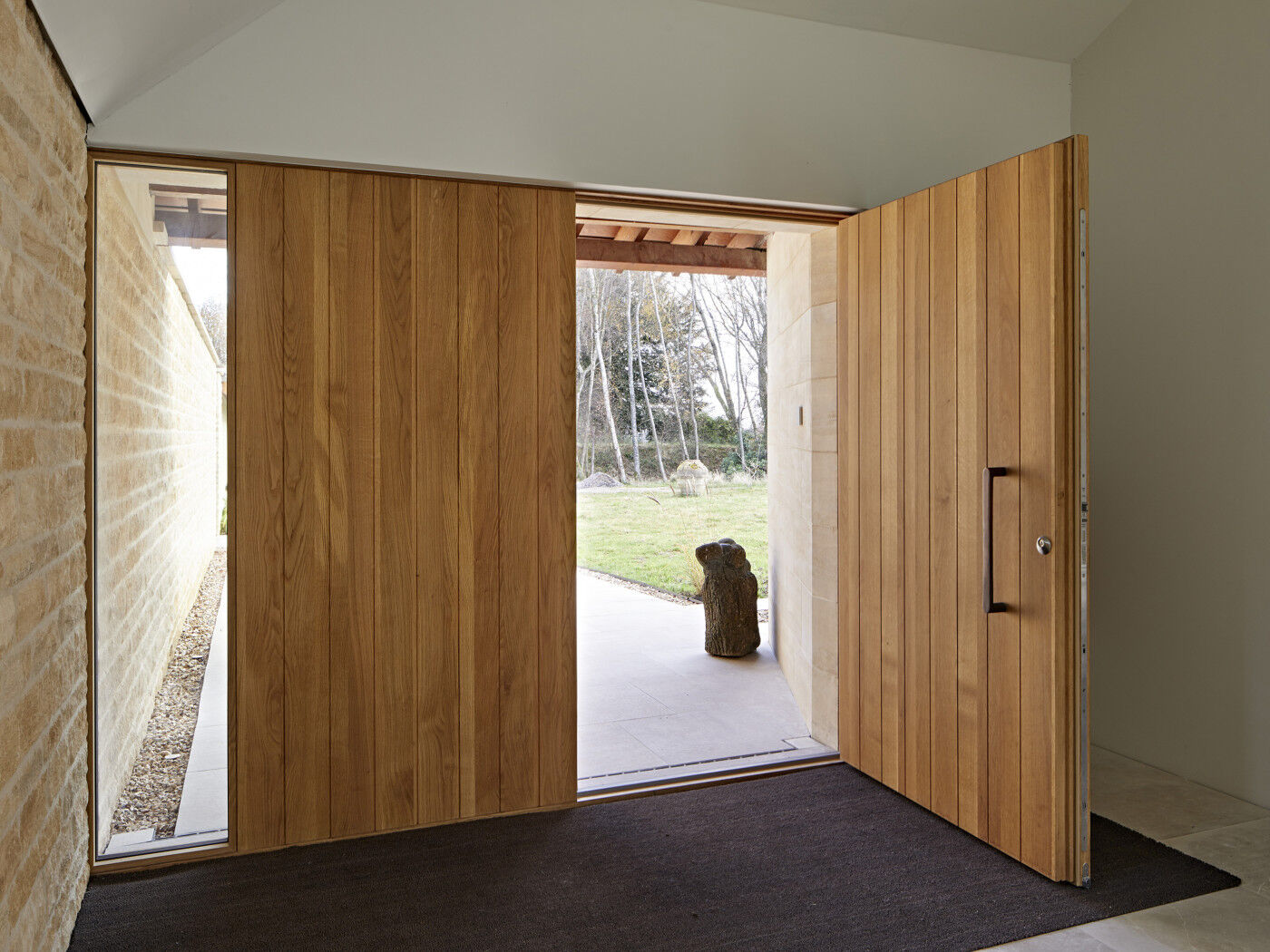 The use of a matching boarded panel creates an impressive entrance.