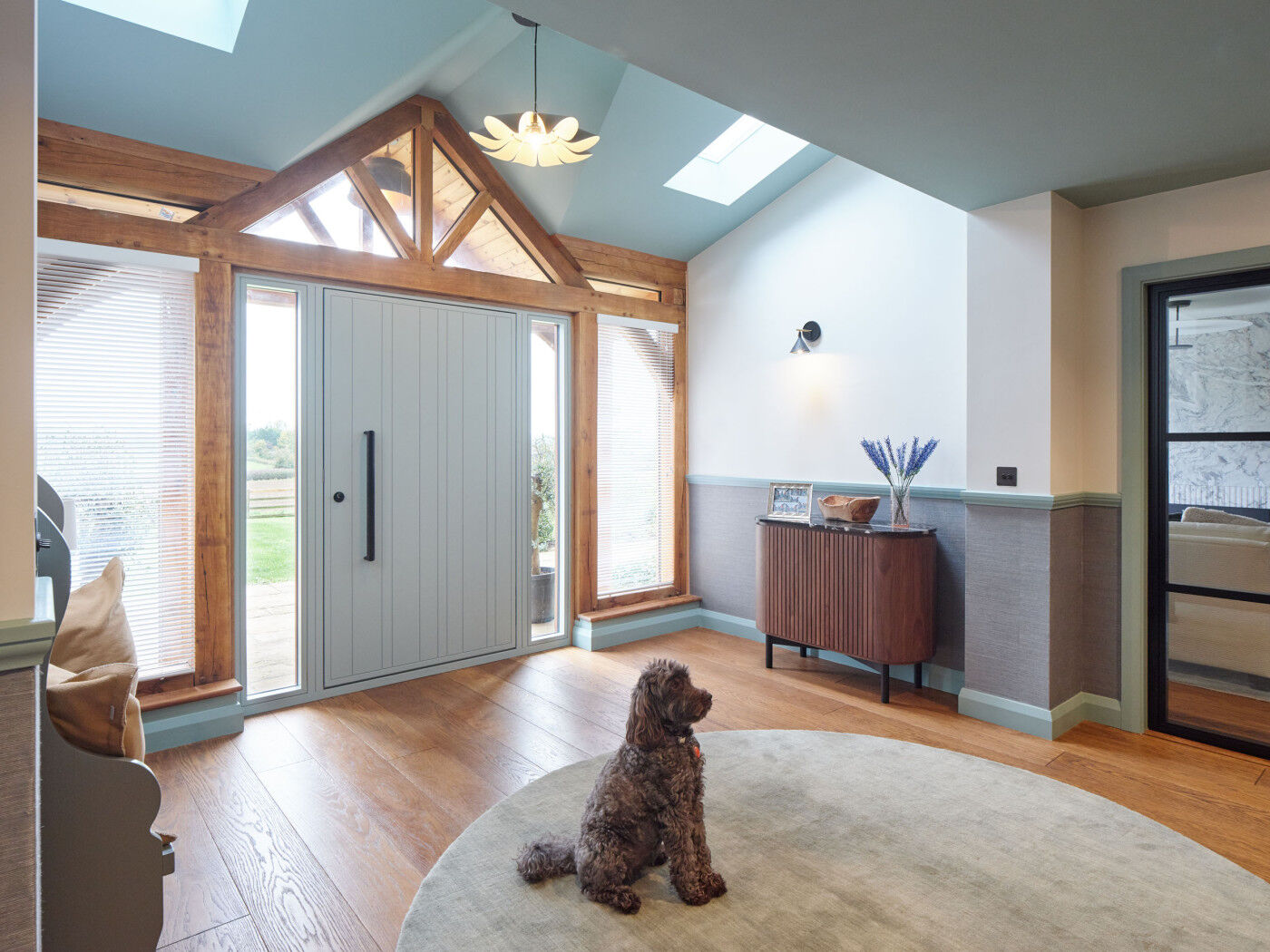 Light floods into the hallway featuring soft blues and greys