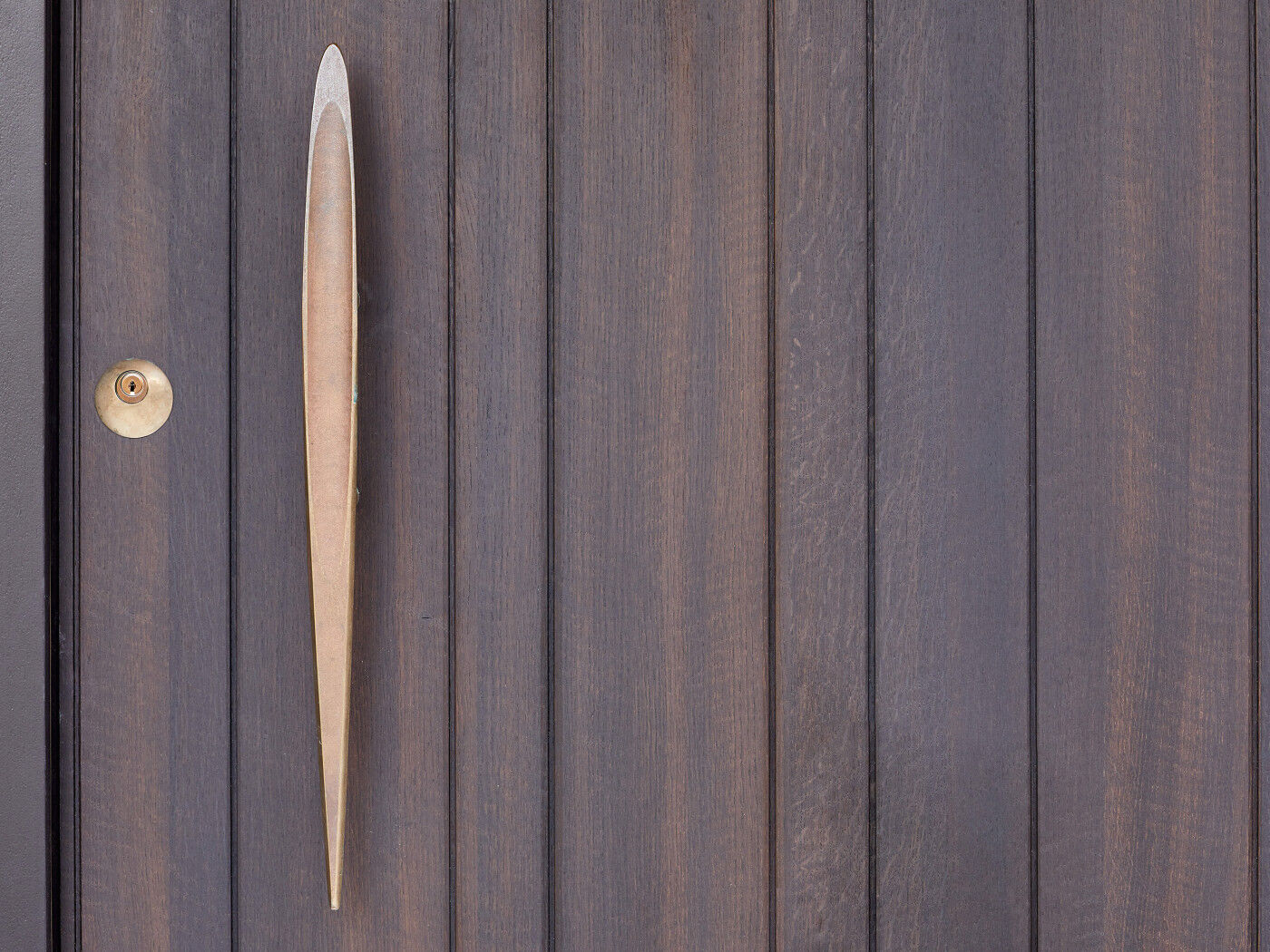 A designer solid cast bronze pull with a dip detail makes a real statement