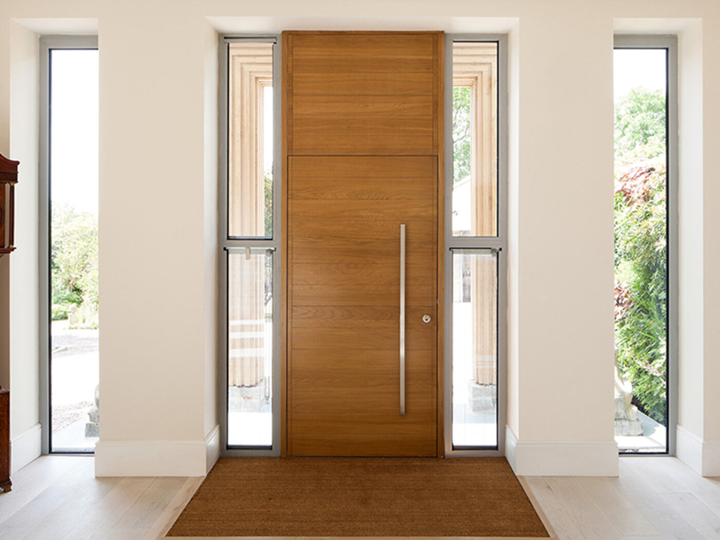 This matching overhead wood panel gives the illusion of extra height and the glass panels keep things light