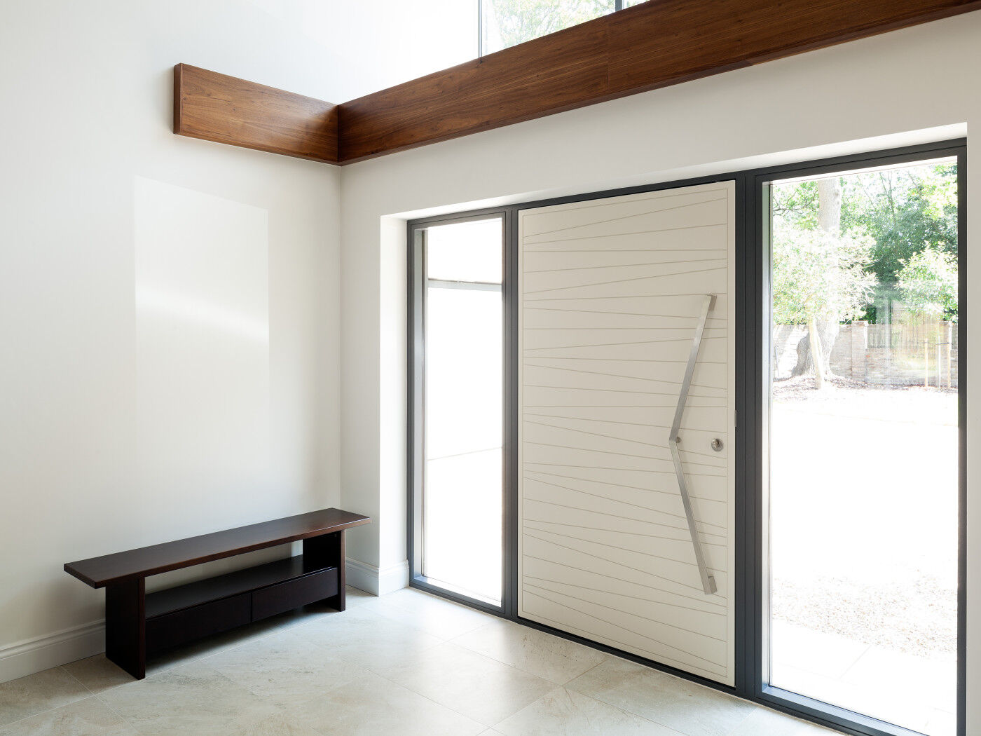Double sidelights (side glass panels) frame this white RAL-painted door