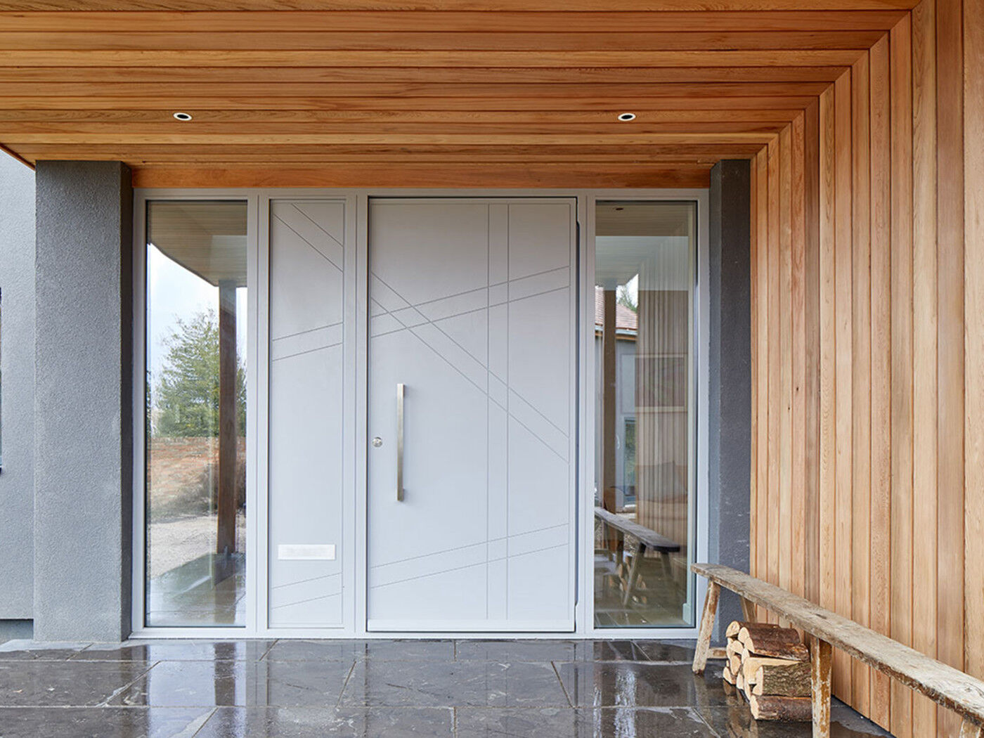 Matching wood panels are popular to create width or height, while glass keeps the hallway well-lit