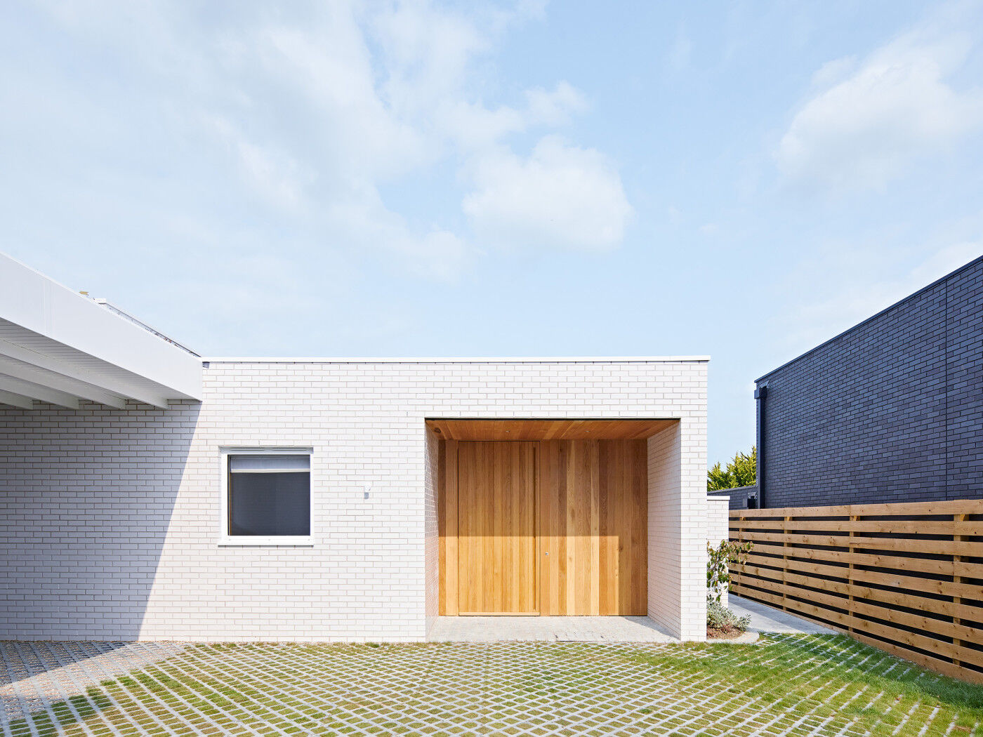 This flush, pivot door is set well back under a broad overhang with side walls for added protection 