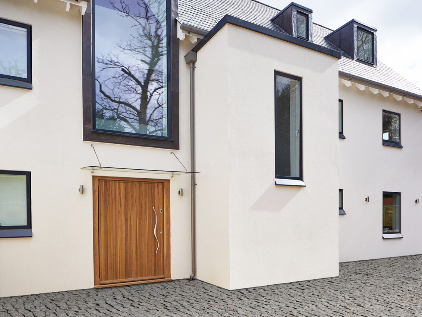 A glass door canopy provides an elegant design feature as well as protection