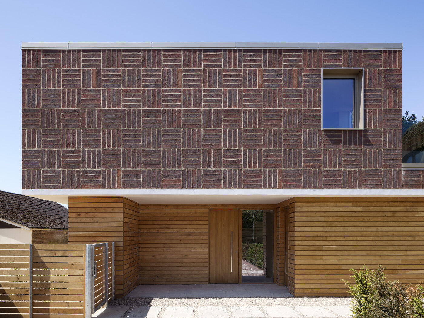 Far from boring, the careful design of this house uses red brick in a thoroughly modern way