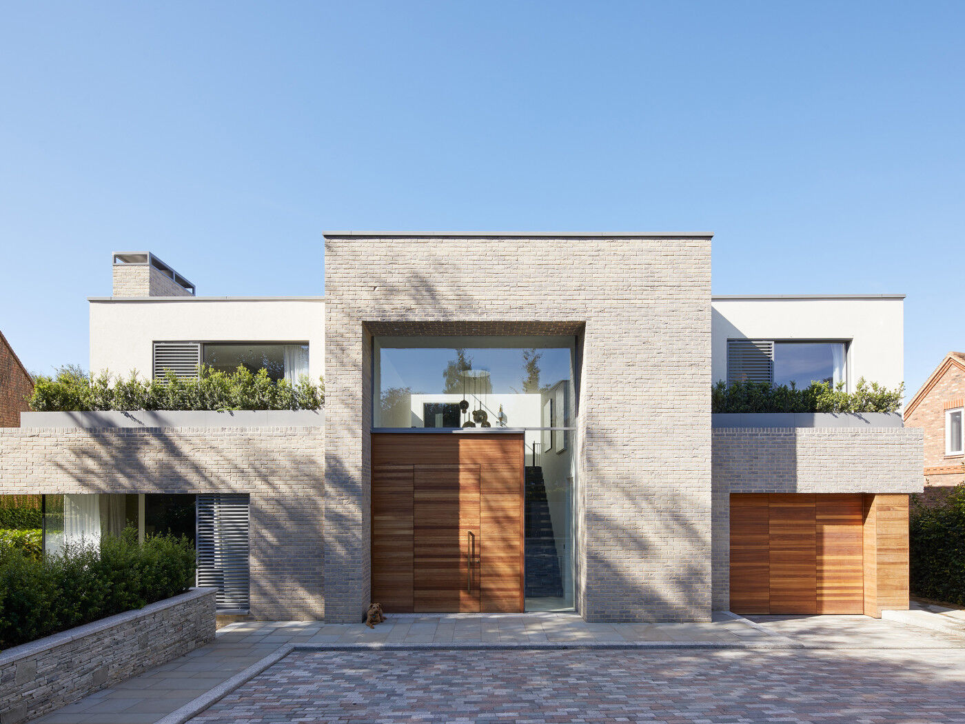 An all-rounder, iroko also works very well with the lighter beige/grey brick of this new build