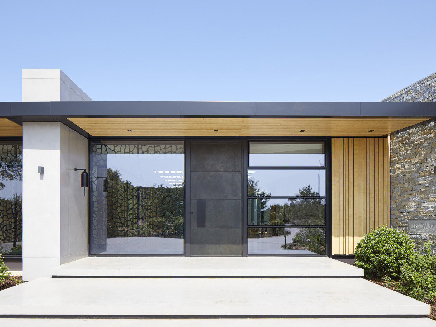 This copper door looks stunning against the architectural glazed wall 