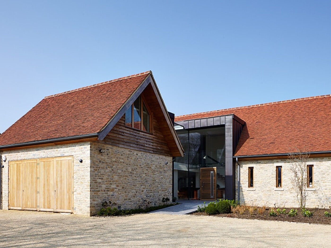 The front door creates impact within a wall of glass