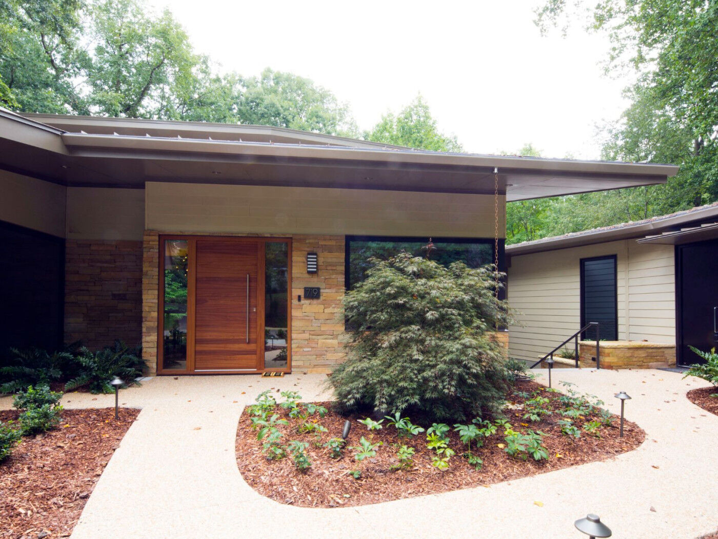The client has opted for a hardwood front door and a painted finish for the secondary door.
