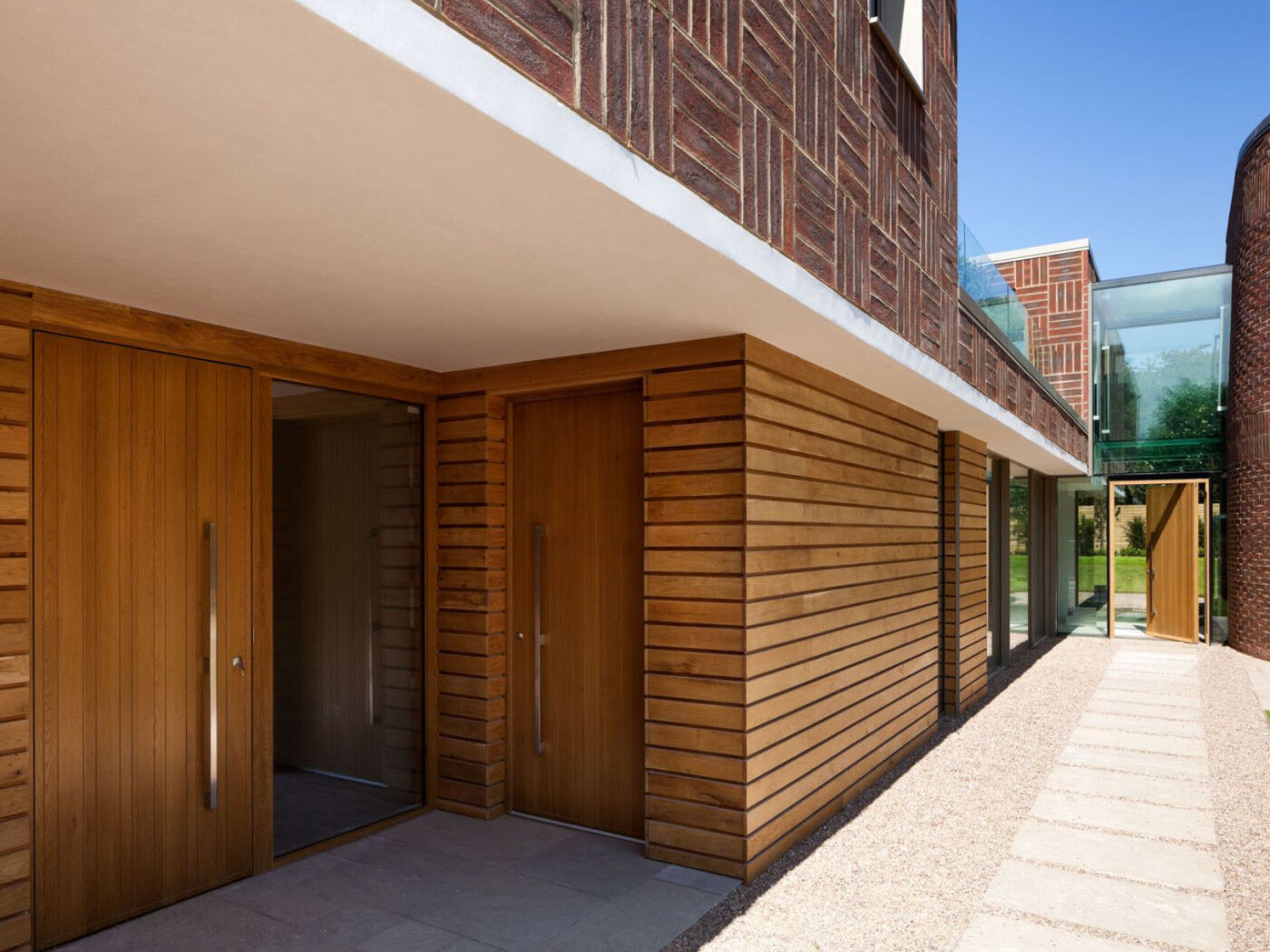 The front (far right) is large and set in glazing while the two secondary doors have the same finish and handles.