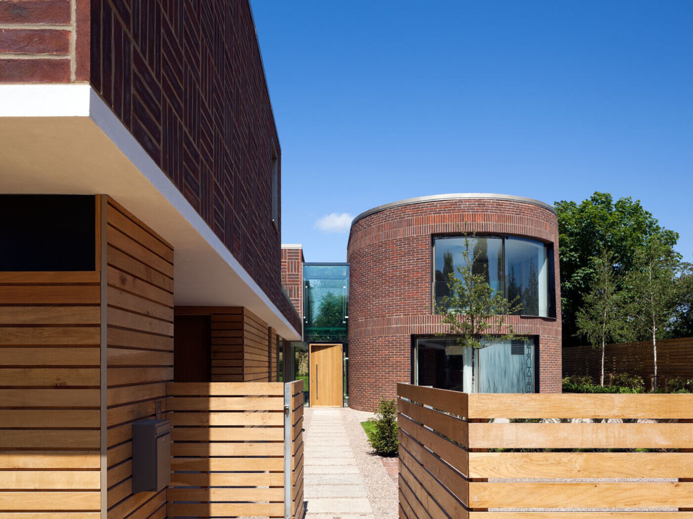 An unusual designed house with circular and square walls with a large door