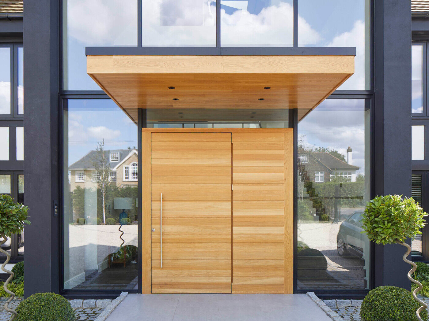large overhangs will help protect a pivot door from exposure