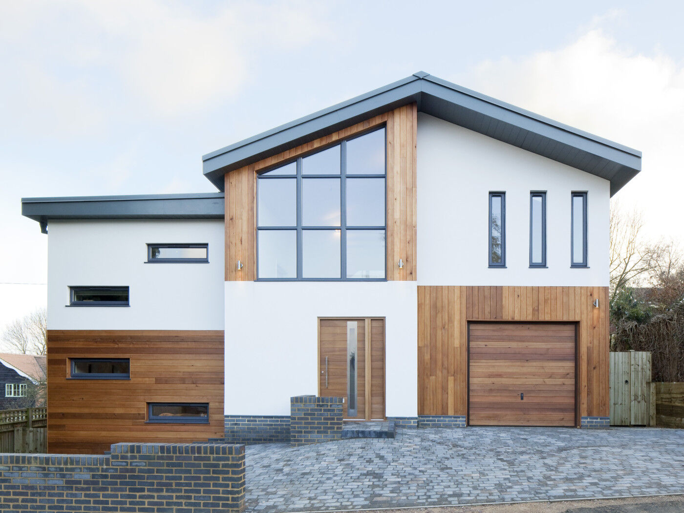 The Sorrento door by Urban Front works beautifully with the wood cladding and garage door