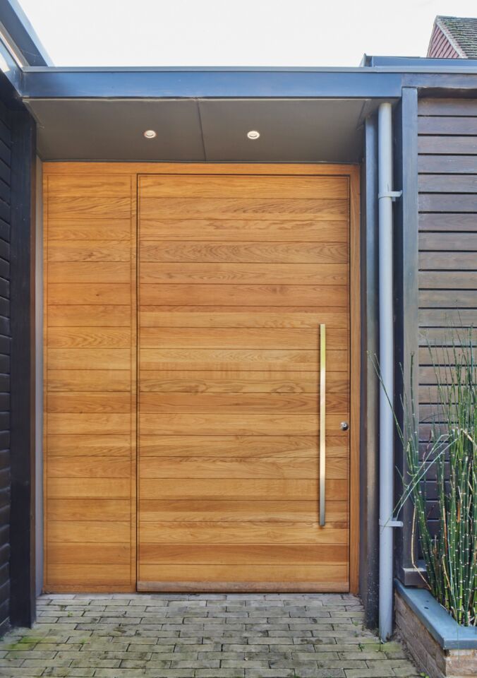 Portrait close up door closed and cladding Fir Tree House