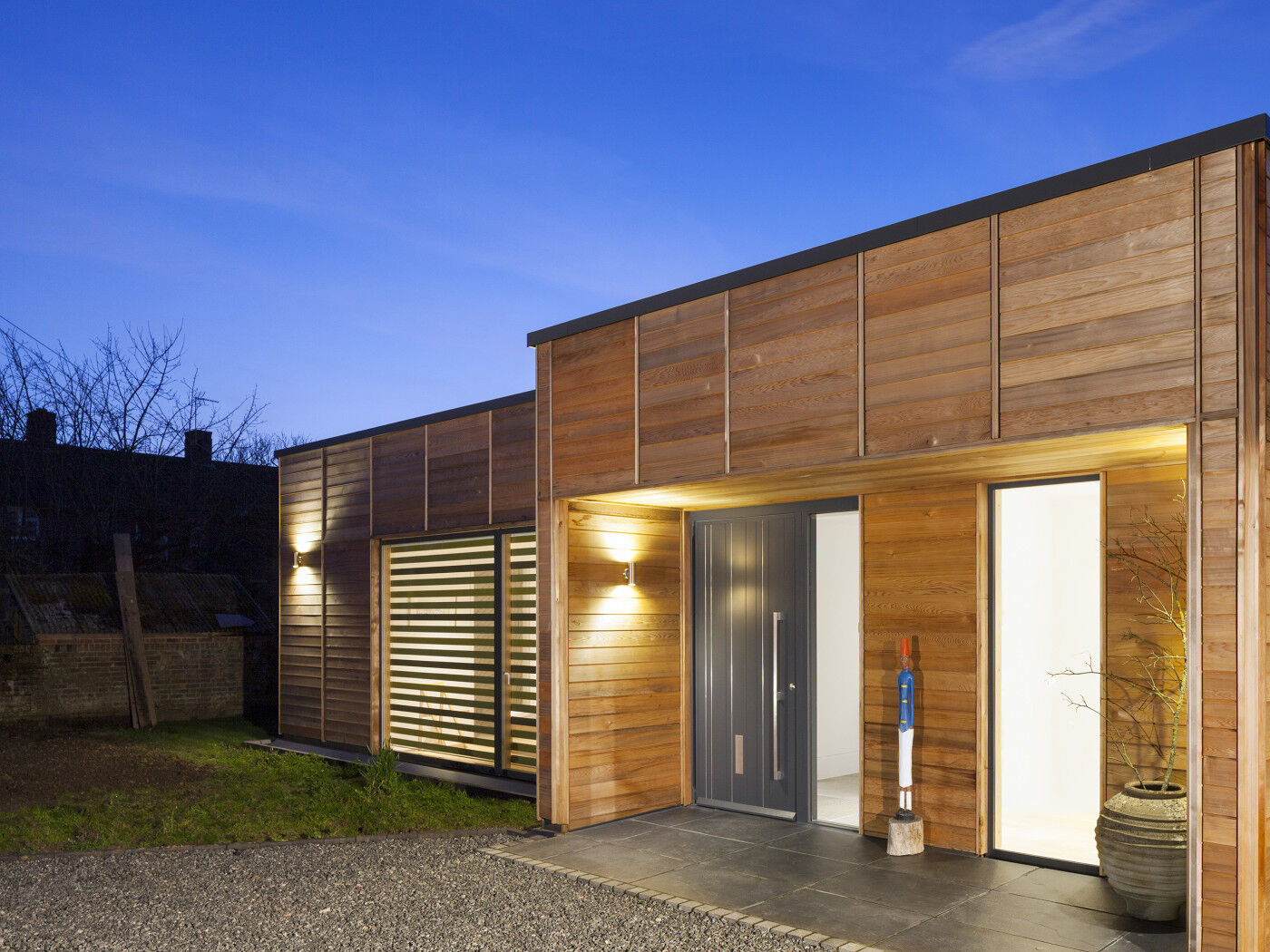 The simple building design works beautifully with the statement grey painted door