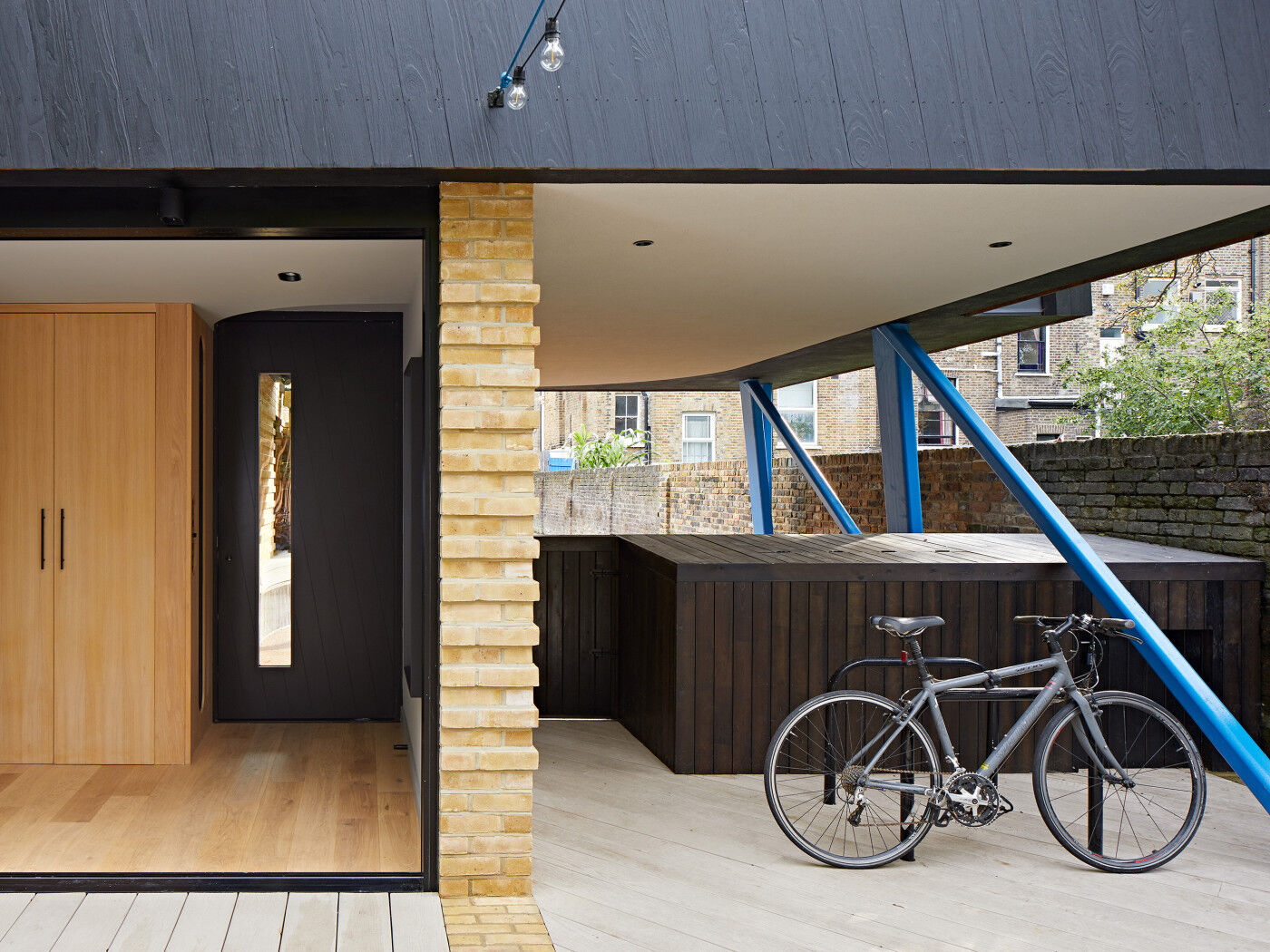 Housed within a variety of other building materials & colours, the black door & cladding offer the perfect neutral base