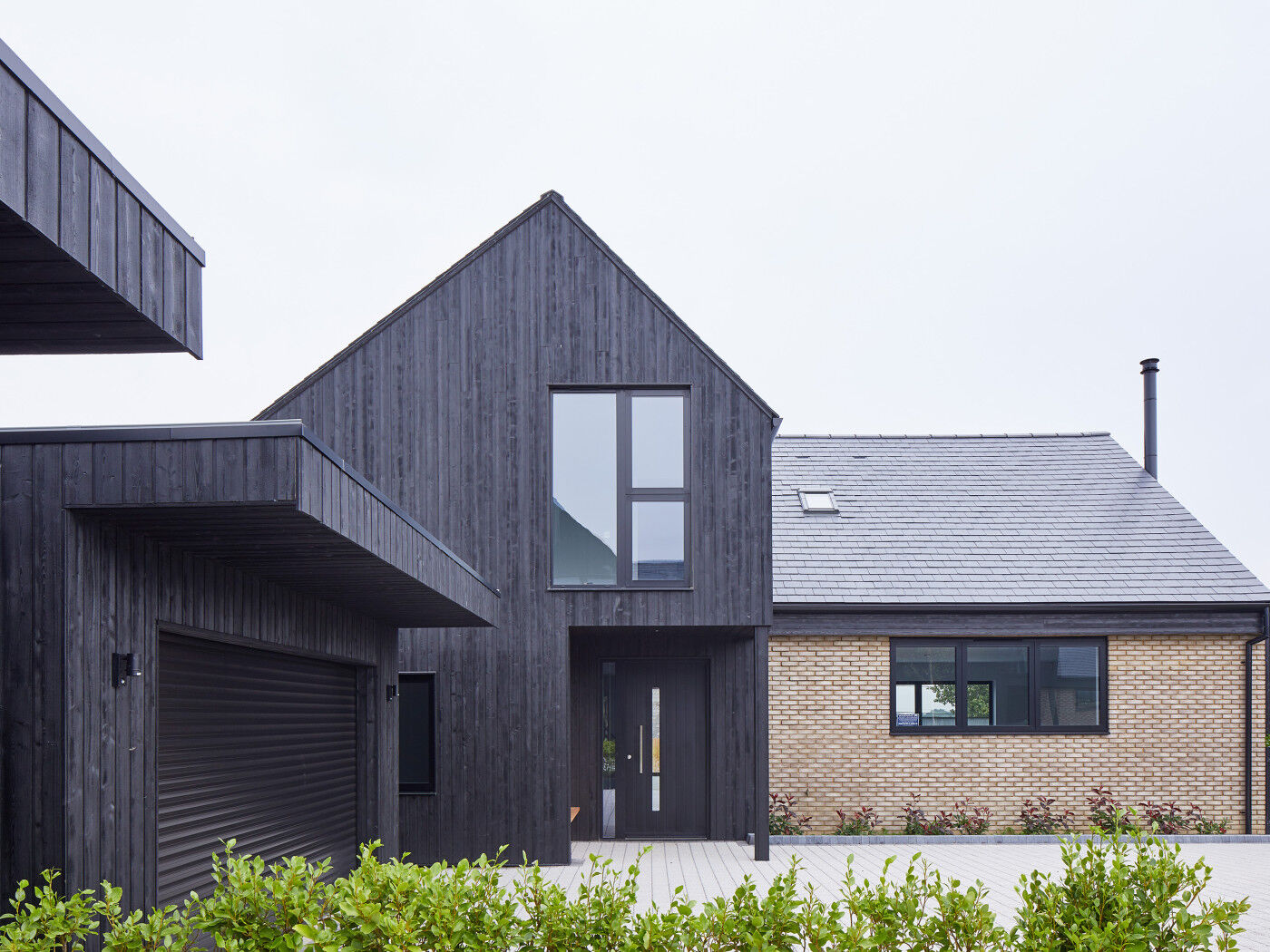 Urban Front's black painted Terano doorsets work well with the charred cladding in this development