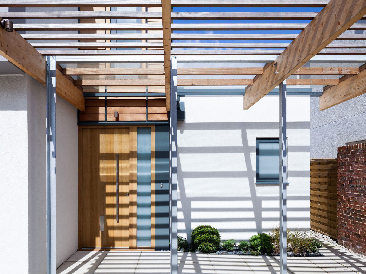 The Porto front door in european oak features a sandblasted glass side panel (side light)