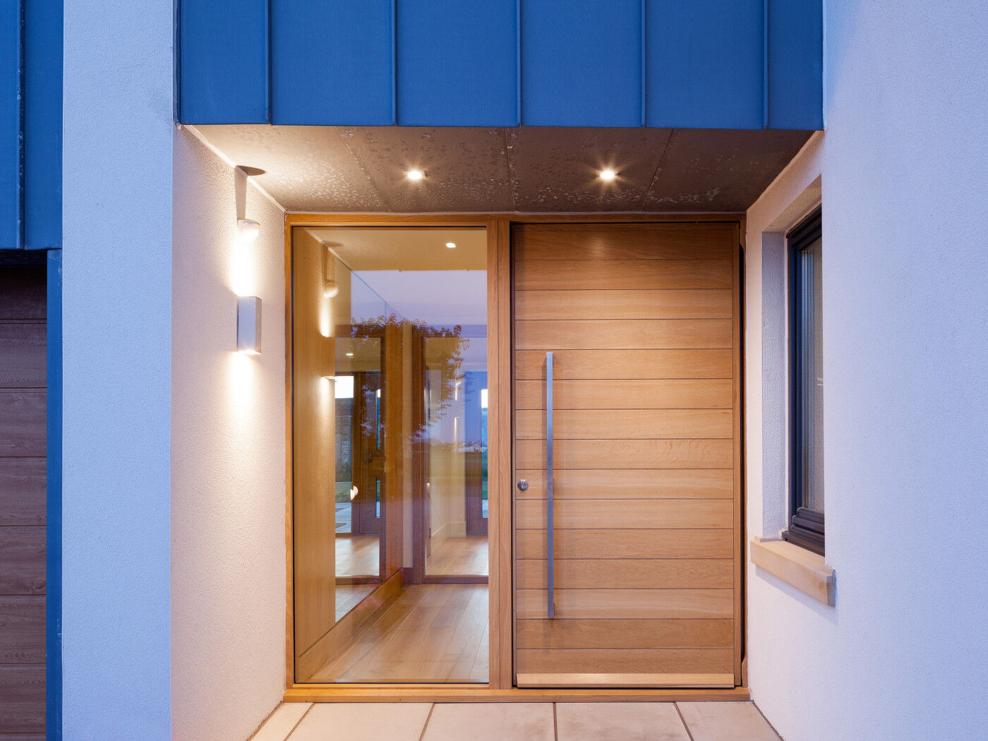 The Parma front door has a glass side panel that complements the glass design in the house
