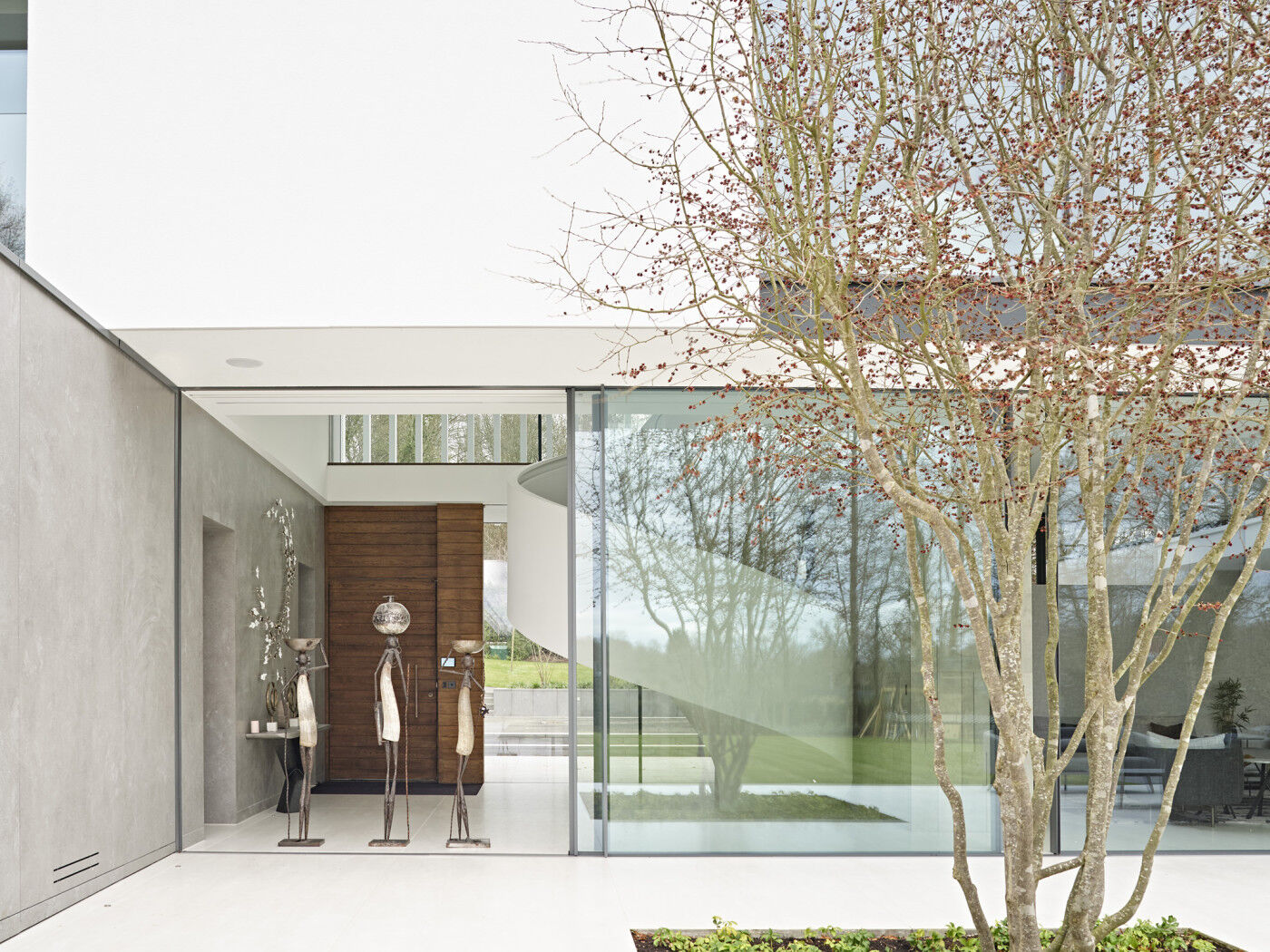 Full height glazing and modern art adds to the spectacular view from the front entrance right through to the back of the house