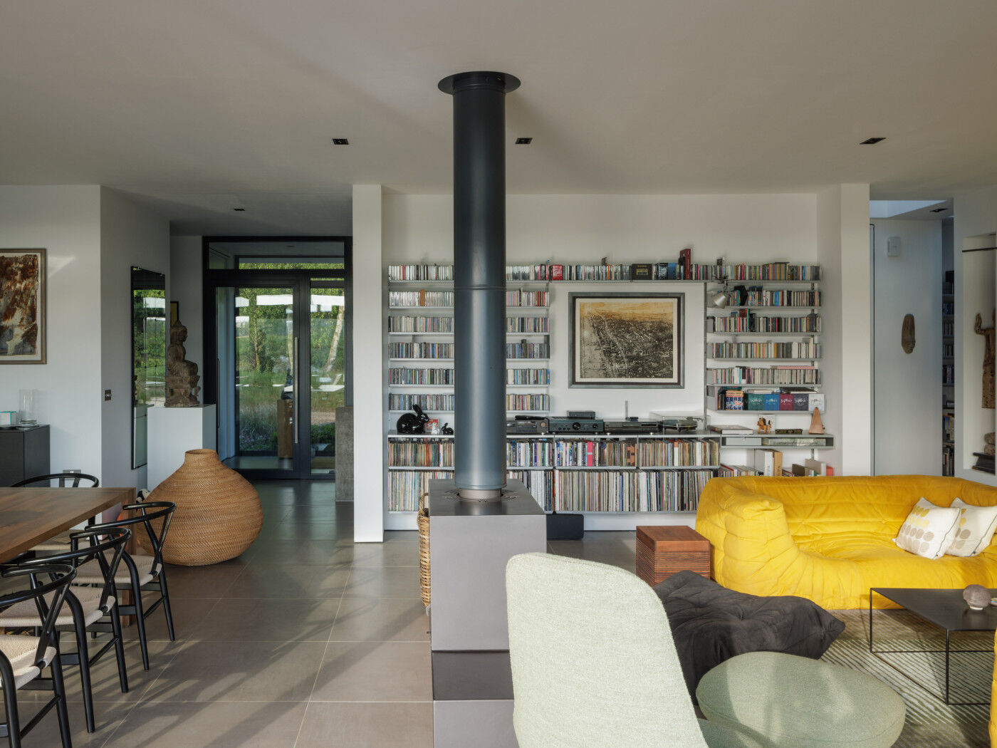 And the open-plan space continues through the lounge area, that is accented by bold yellow sofas