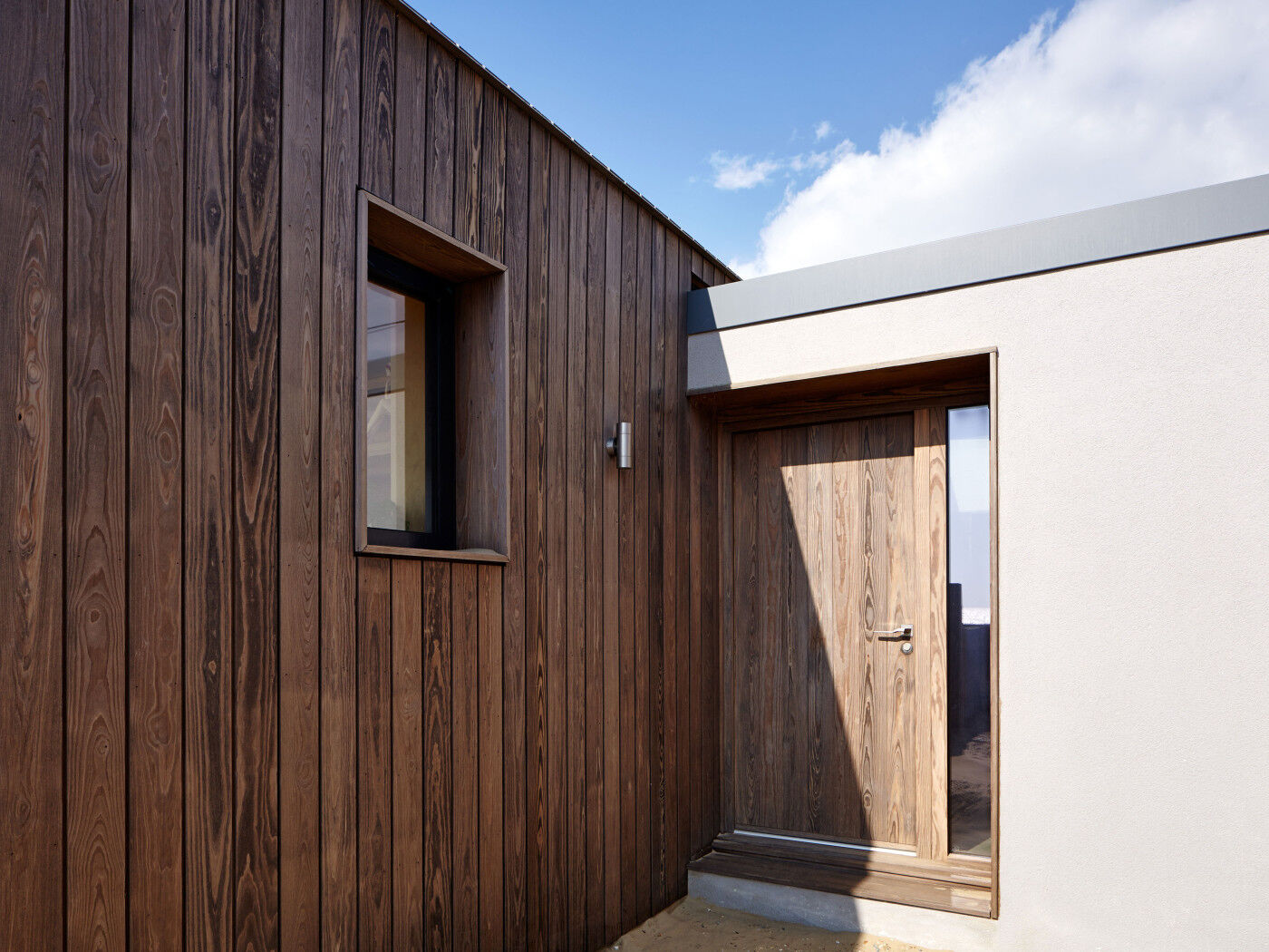 The contemporary Porto front door matches the exterior cladding