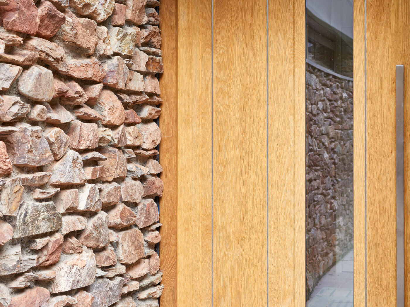 Stainless steel strips expertly contrast with the european oak and exterior stonework