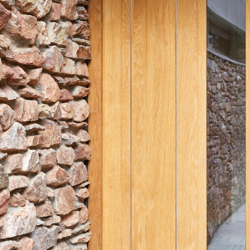 Stainless steel strips expertly contrast with the european oak and exterior stonework