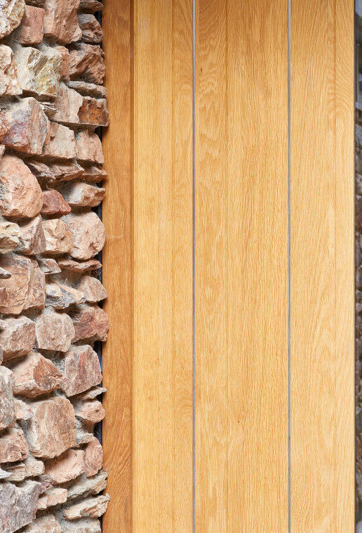Stainless steel strips expertly contrast with the european oak and exterior stonework