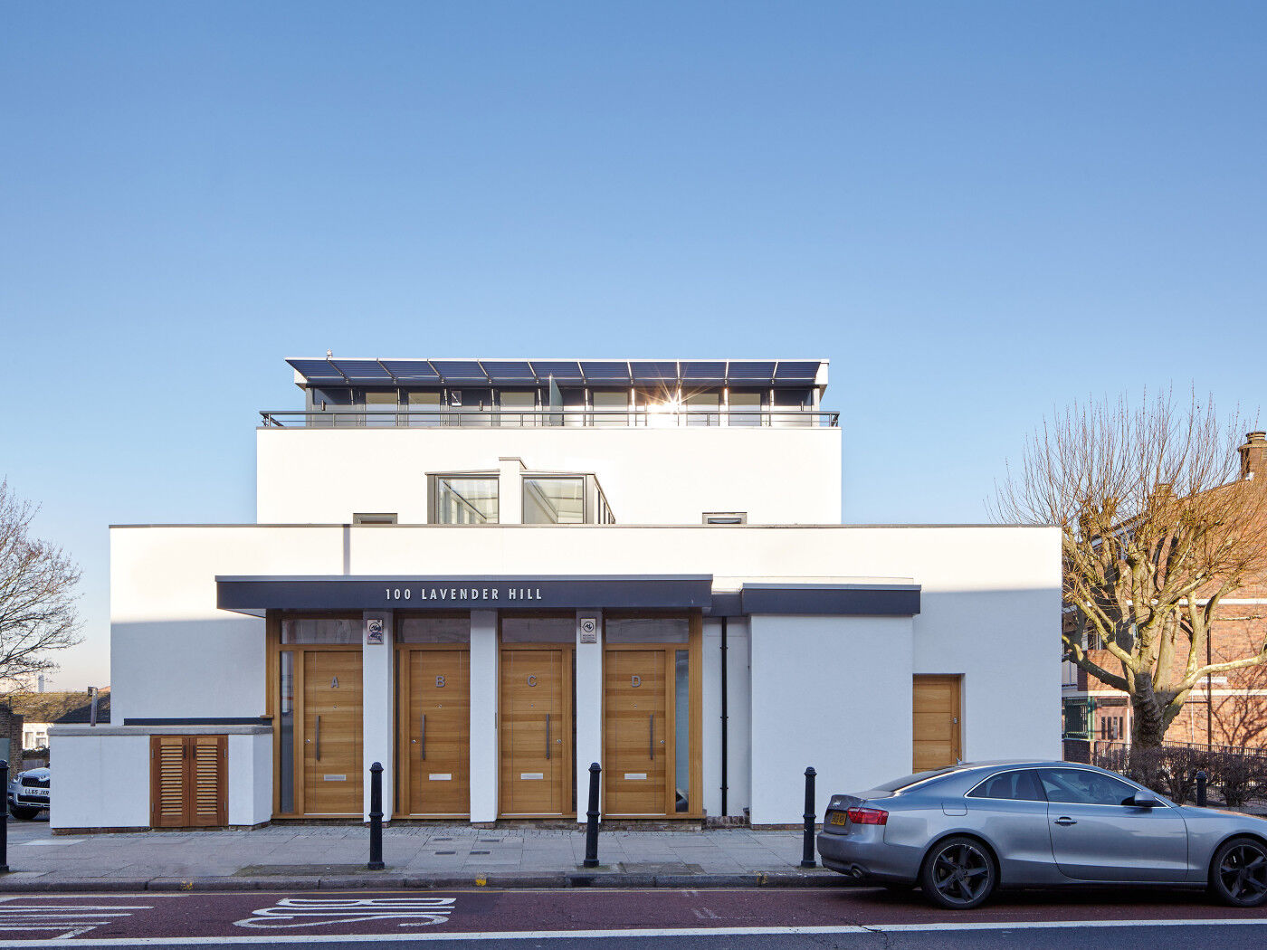 European Oak doors, offer warmth to the white render and grey detail 