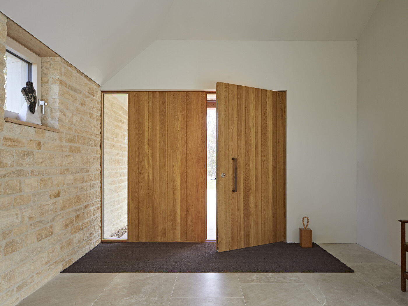 The door is made with vertically grained European oak wood that matches the vertical design
