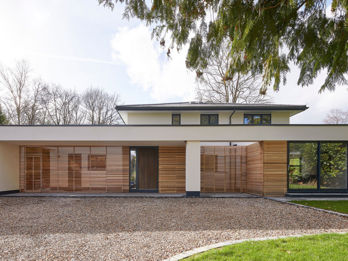 A wonderful example of modern architecture with a fumed oak wood front door