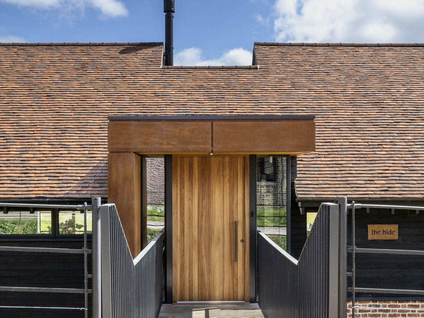 Urban Front's Rondo V front door in iroko sets off the entrance to this incredible modern rebuild