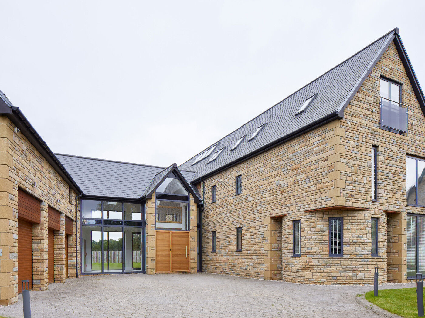 These unique "U" shaped houses feature Urban Front's Parma door in iroko