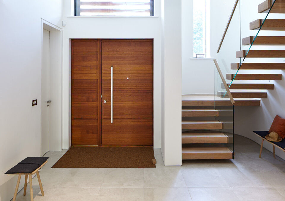 The contemporary front door is matched by the modern interior