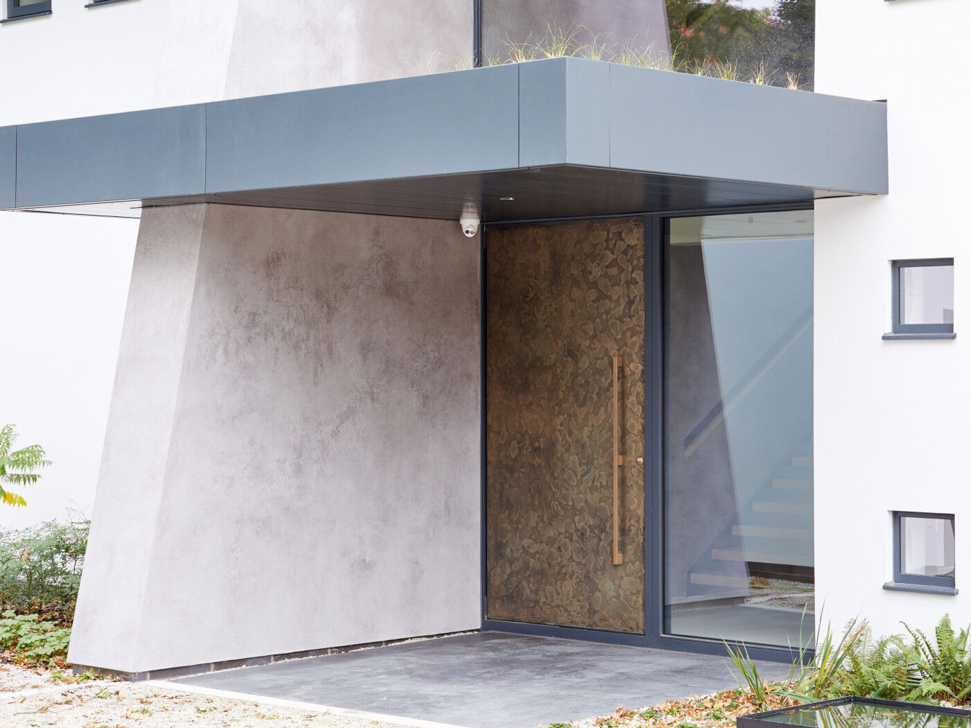 Bronze door against stone exterior | Urban Front