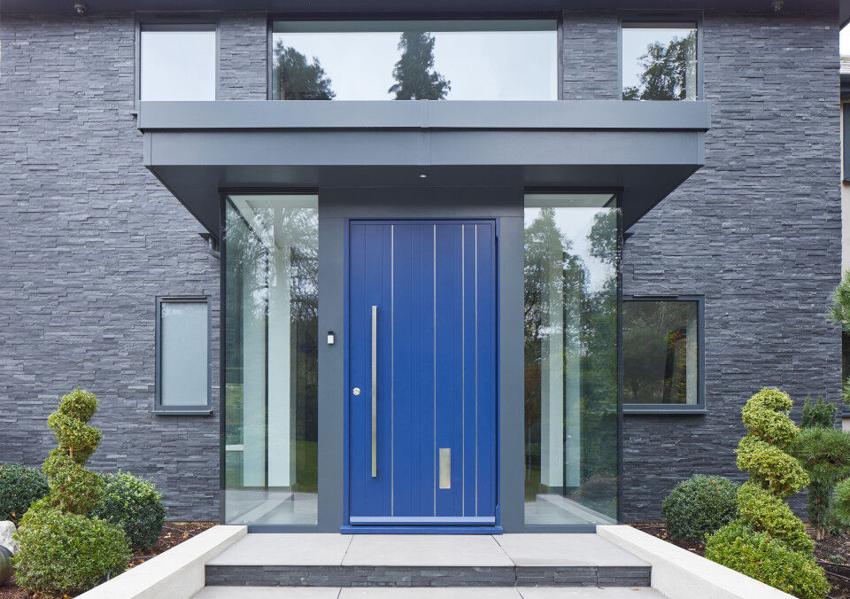 Frameless glass houses this blue door