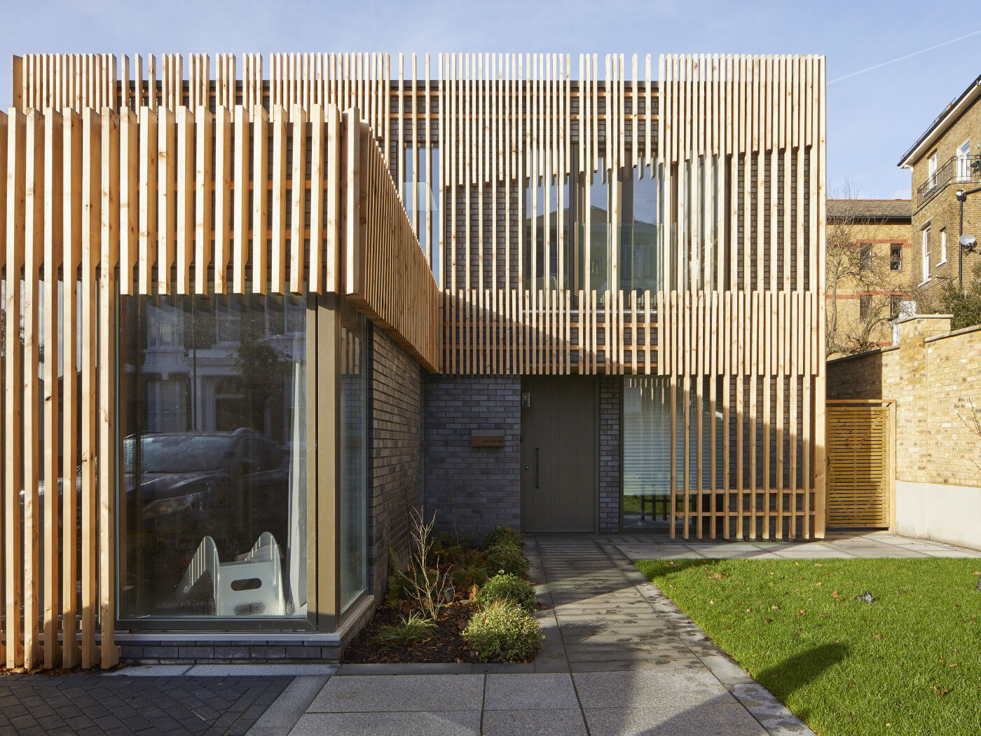 This rich deep olive green door was chosen to work with the windows and the statement cladding
