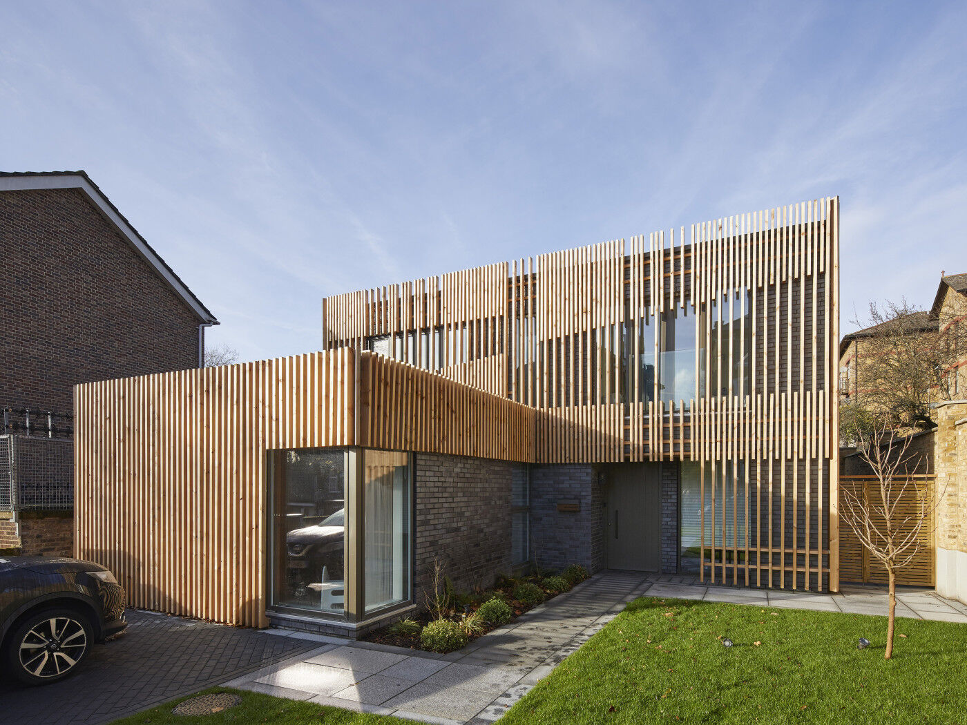 Our vertical Porto door is the perfect design match for the cladding 