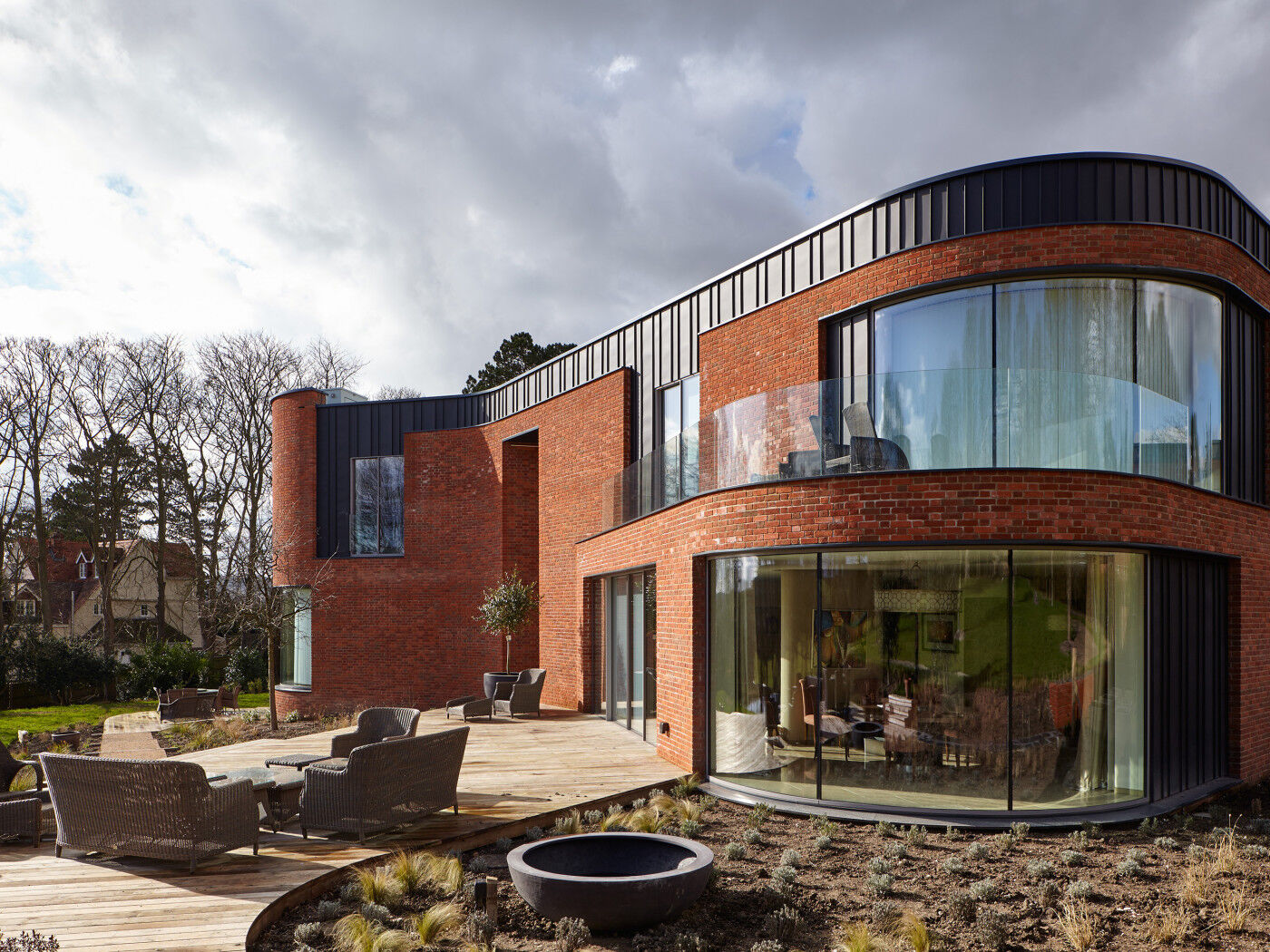 The curved passive house design features 5 Urban Front external doors 