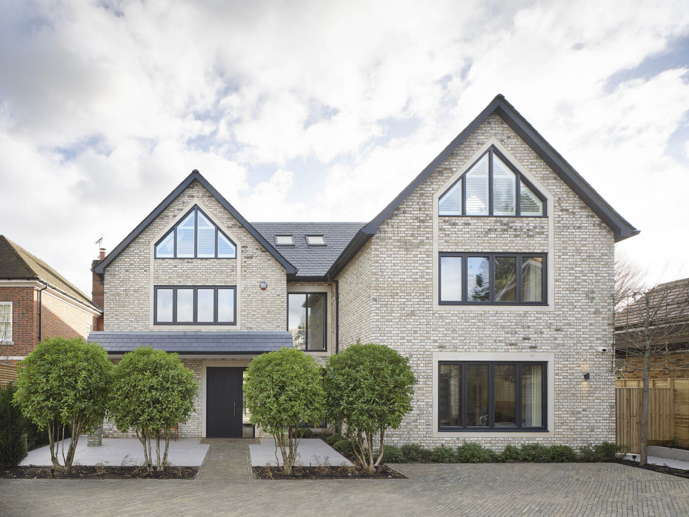 A traditional style home given a contemporary twist with large windows and an Urban Front door.