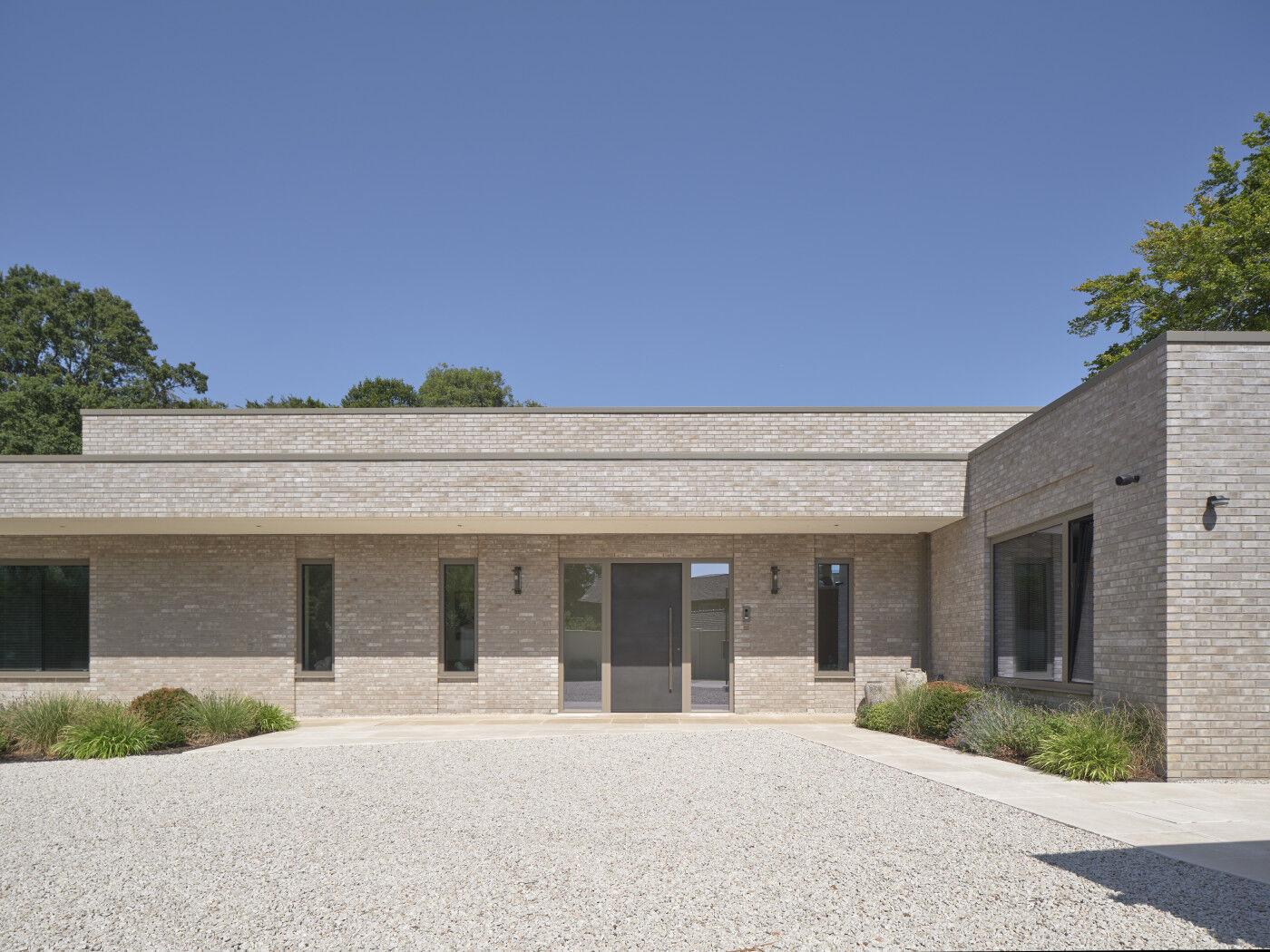 This new build in a Greenbelt location pairs pale brick with a bronze front door.