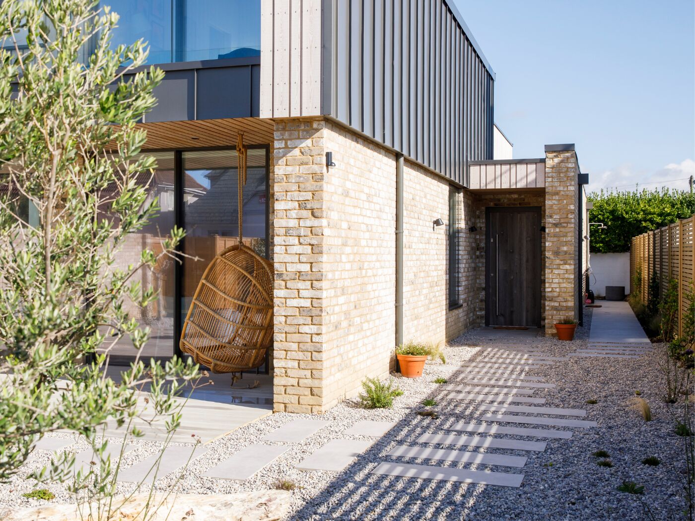A coastal home with a barn door chosen to echo driftwood found at the beach.