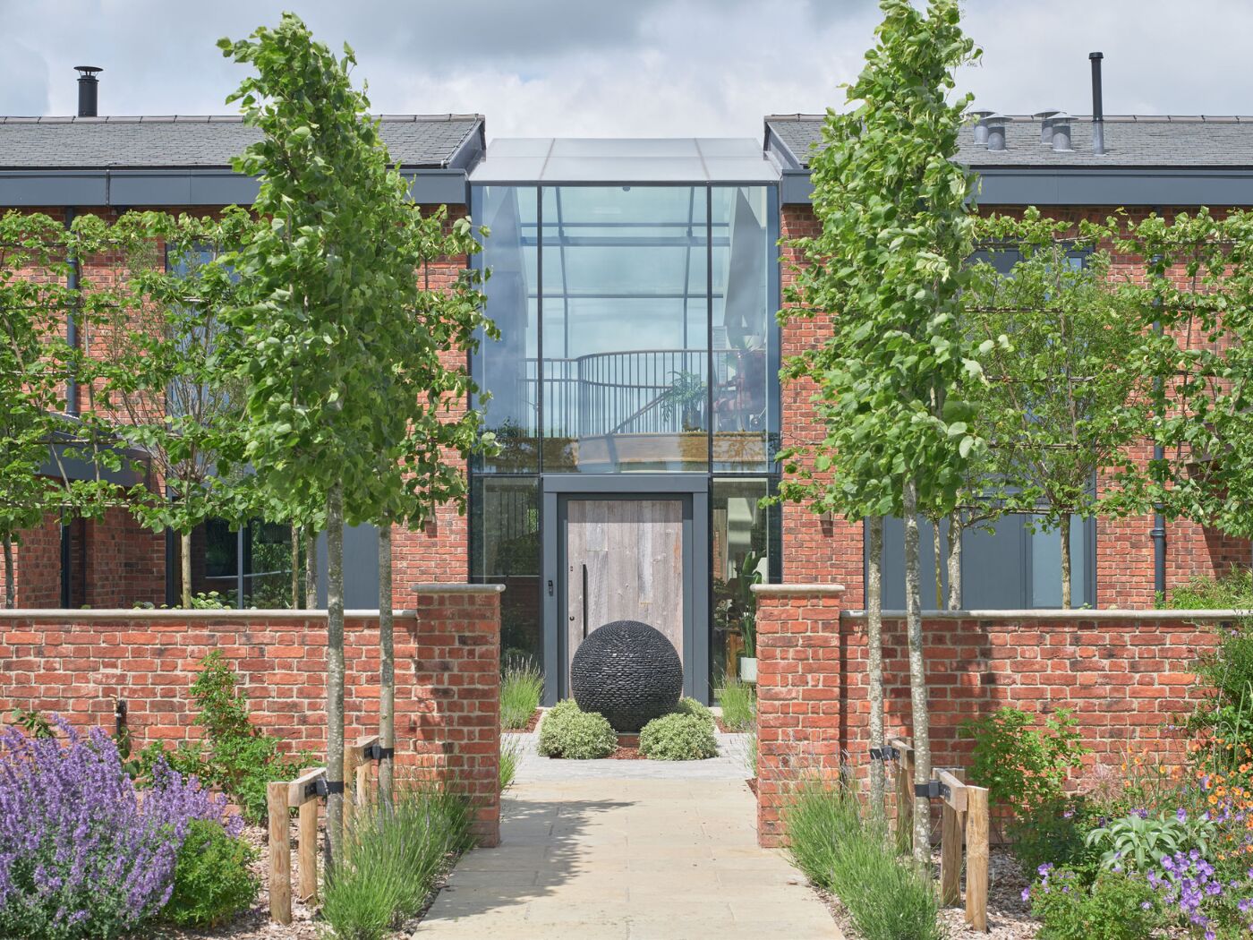 The reclaimed wood of the barn door creates impact within the architectural glazing.