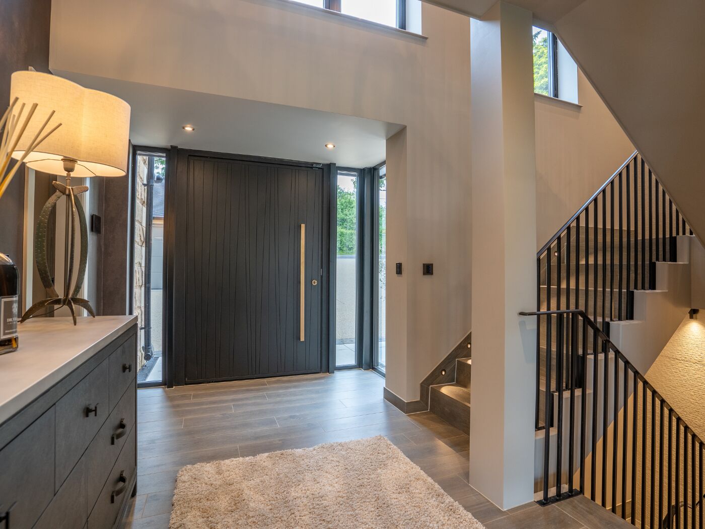 A statement Milano V door in oak finished in ebony oil with symmetrical sidelights.