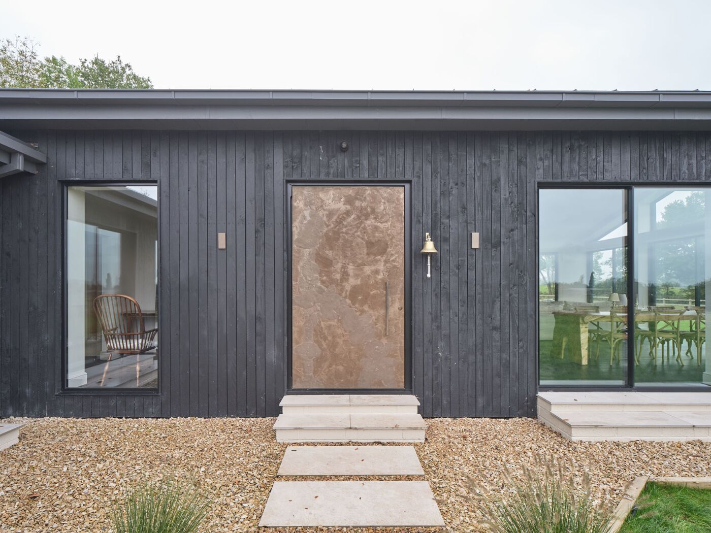 A bronze door adds to this converted barn's feeling of understated luxury.