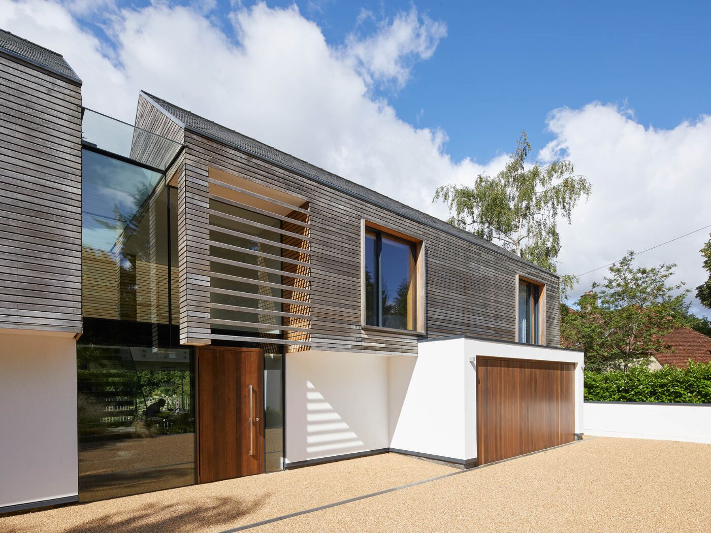 The hardwood front and garage doors stand out on this modern home.